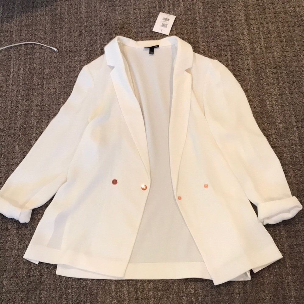 white blazer with rose gold buttons.